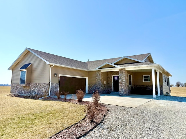 single story home featuring a front yard, roof with shingles, concrete driveway, a garage, and stone siding