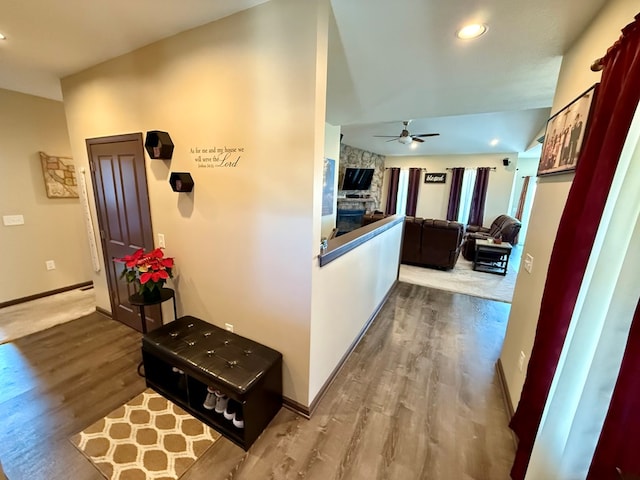 hallway with recessed lighting, wood finished floors, and baseboards