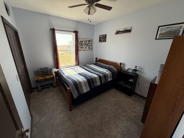 carpeted bedroom featuring a textured ceiling and a ceiling fan