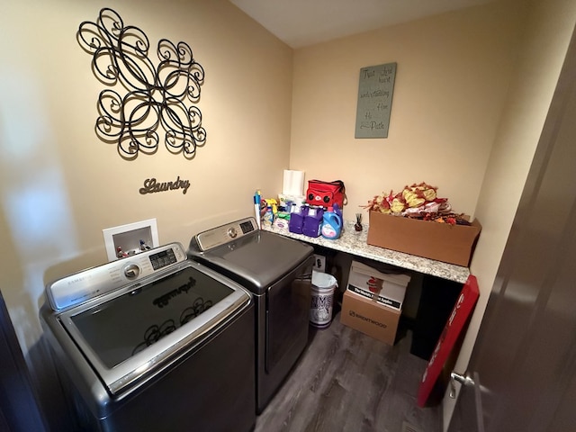 clothes washing area featuring laundry area, dark wood-style floors, and independent washer and dryer