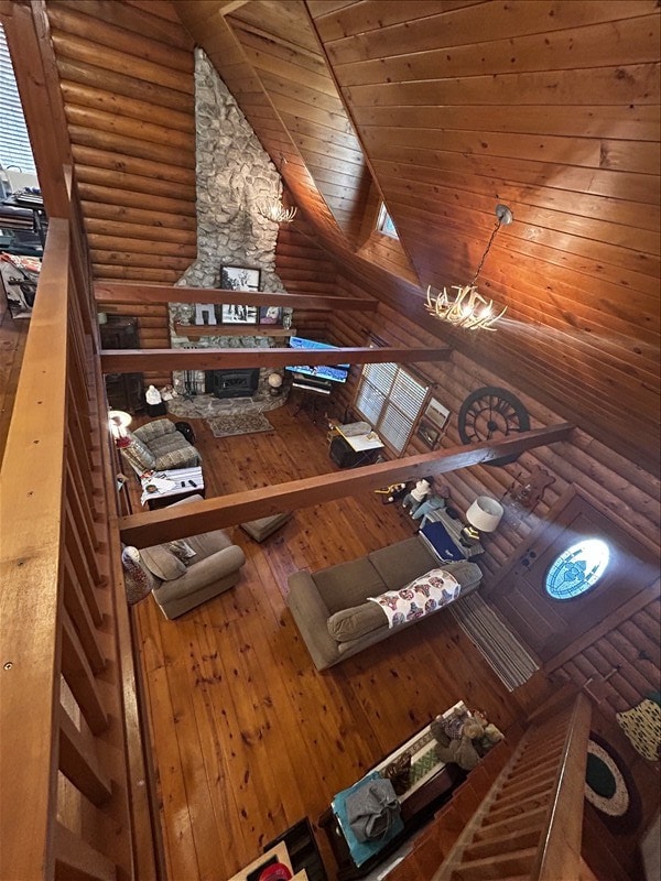 28730 State Highway T, Excello, MO 65247 - living room featuring log walls, wood ceiling, hardwood / wood-style floors, and vaulted ceiling