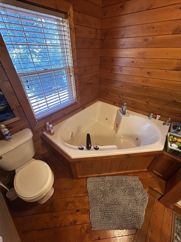 28730 State Highway T, Excello, MO 65247 - bathroom with a jetted tub, hardwood / wood-style flooring, and wood walls