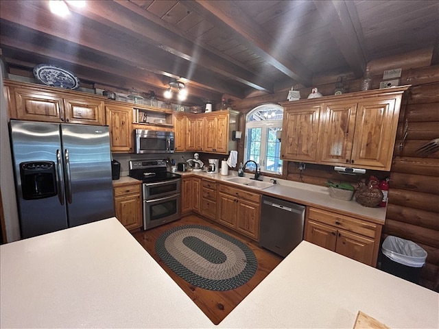 28730 State Highway T, Excello, MO 65247 - kitchen featuring appliances with stainless steel finishes, rustic walls, light countertops, dark wood-type flooring, and open shelves