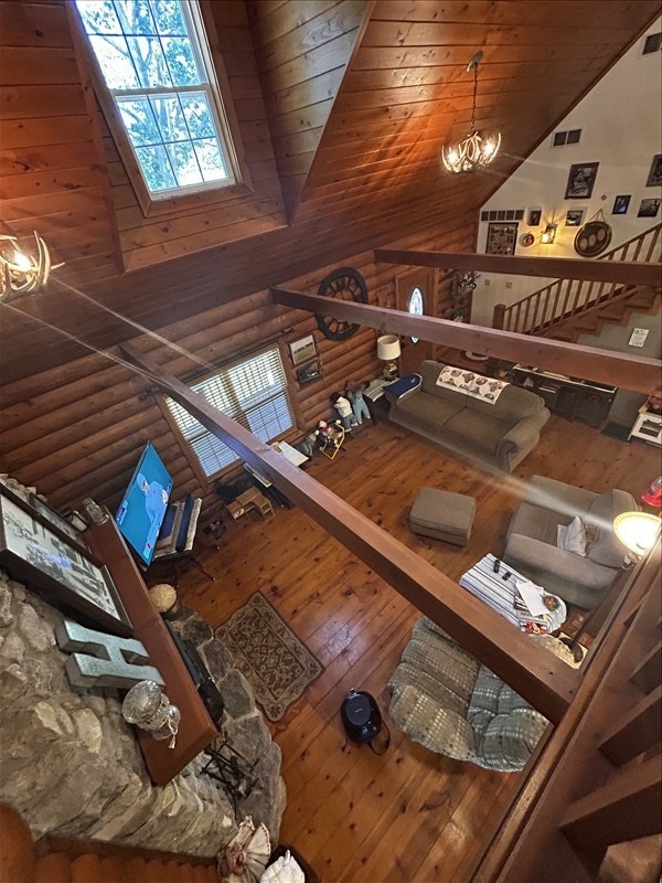 28730 State Highway T, Excello, MO 65247 - living room with hardwood / wood-style flooring, high vaulted ceiling, wood ceiling, and rustic walls