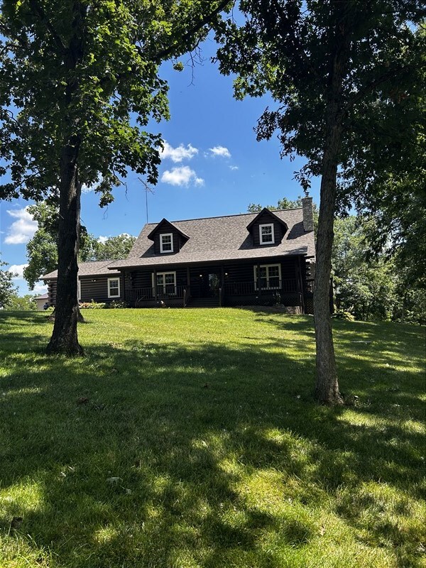 28730 State Highway T, Excello, MO 65247 - view of front of home featuring a front yard and a chimney
