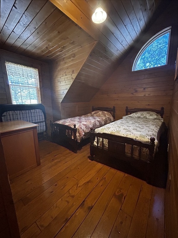 28730 State Highway T, Excello, MO 65247 - bedroom featuring wooden ceiling, wooden walls, hardwood / wood-style flooring, and lofted ceiling