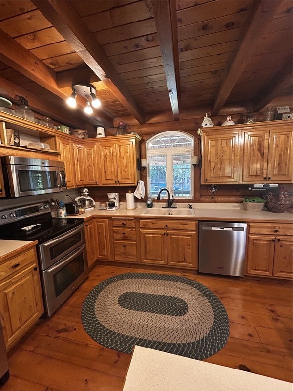 28730 State Highway T, Excello, MO 65247 - kitchen featuring appliances with stainless steel finishes, a wooden ceiling with exposed beams, wood-type flooring, and light countertops