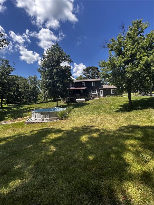 28730 State Highway T, Excello, MO 65247 - view of grassy yard with an outdoor pool and a wooden deck