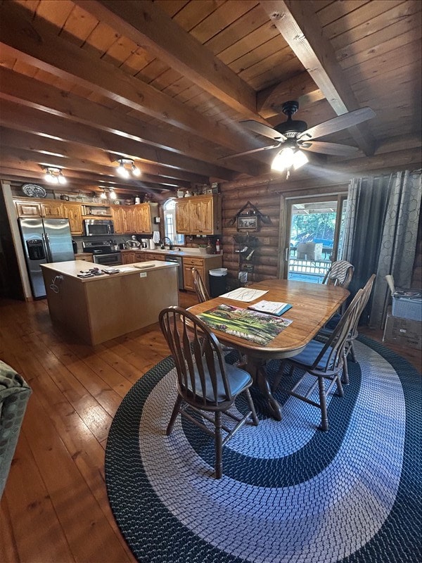 28730 State Highway T, Excello, MO 65247 - dining area with dark wood finished floors, plenty of natural light, a wooden ceiling with exposed beams, a ceiling fan, and log walls