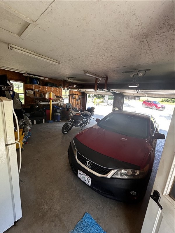 28730 State Highway T, Excello, MO 65247 - garage with freestanding refrigerator