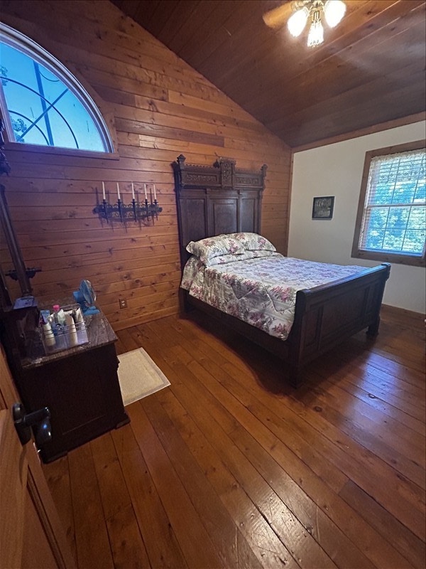 28730 State Highway T, Excello, MO 65247 - bedroom with vaulted ceiling, wood ceiling, wood-type flooring, and wood walls