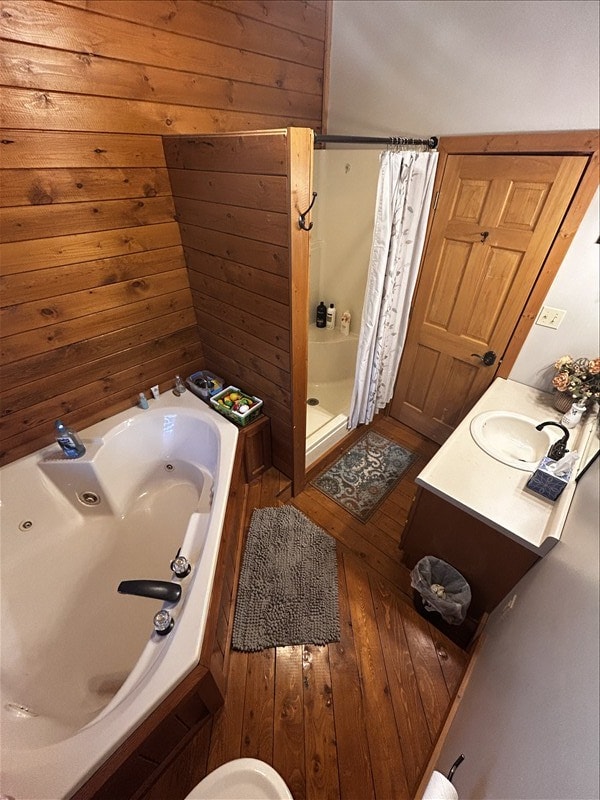 28730 State Highway T, Excello, MO 65247 - bathroom featuring a shower stall, a tub with jets, wood-type flooring, vanity, and wood walls