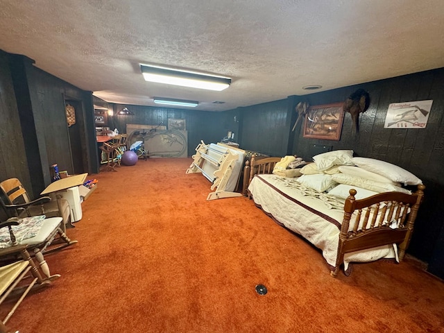 carpeted bedroom with wooden walls and a textured ceiling