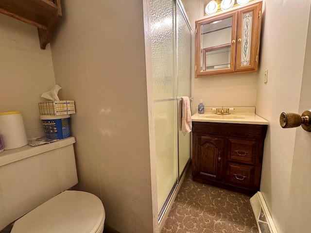 bathroom featuring a shower stall, baseboards, toilet, baseboard heating, and vanity