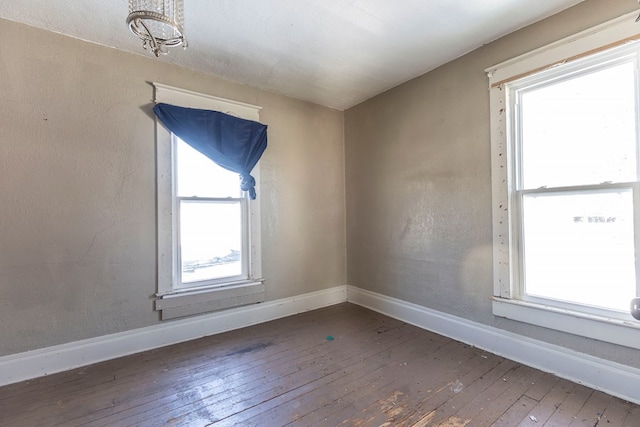 unfurnished room with dark wood-type flooring