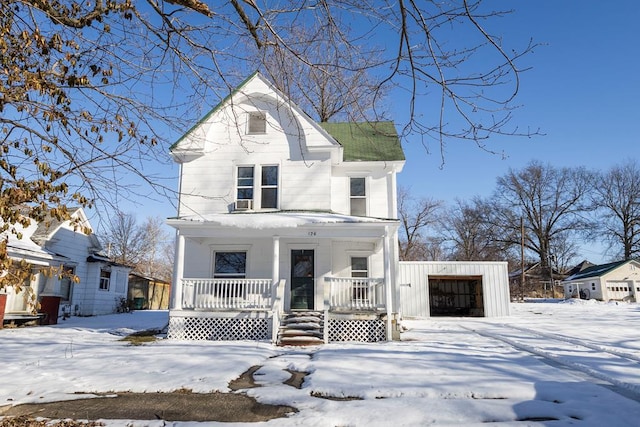 view of front of house with a garage, an outdoor structure, and a porch