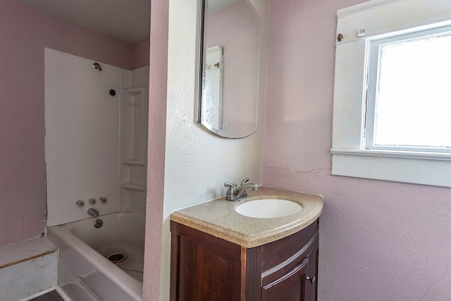 bathroom featuring washtub / shower combination and vanity