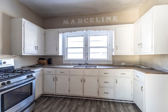 kitchen with white cabinets, sink, dark wood-type flooring, and stainless steel gas range