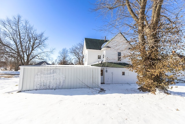 view of snow covered rear of property