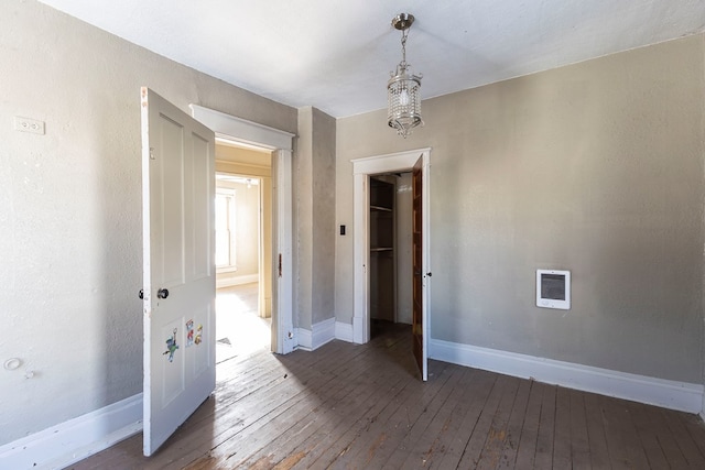 empty room with dark hardwood / wood-style flooring