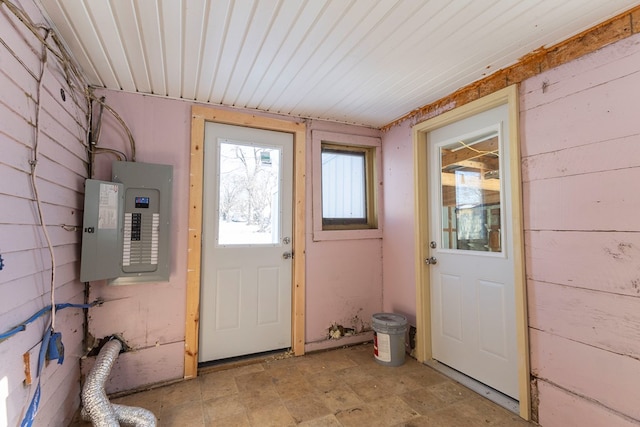 entryway featuring electric panel and wooden walls