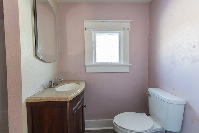 bathroom featuring toilet and vanity