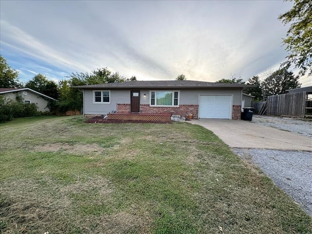 single story home featuring a garage and a front lawn