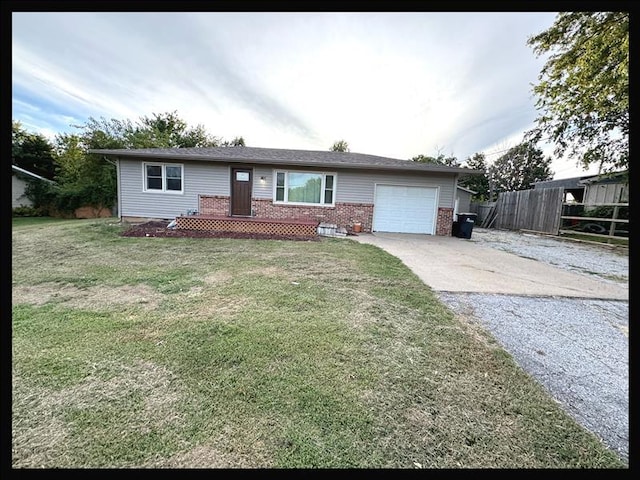 ranch-style home with a front lawn and a garage