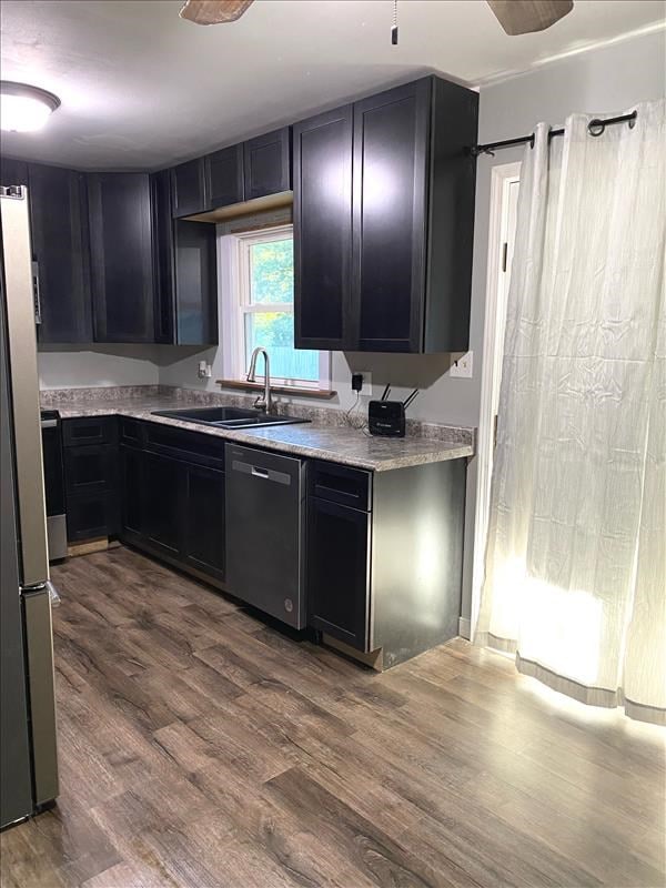 kitchen with ceiling fan, wood-type flooring, sink, and appliances with stainless steel finishes