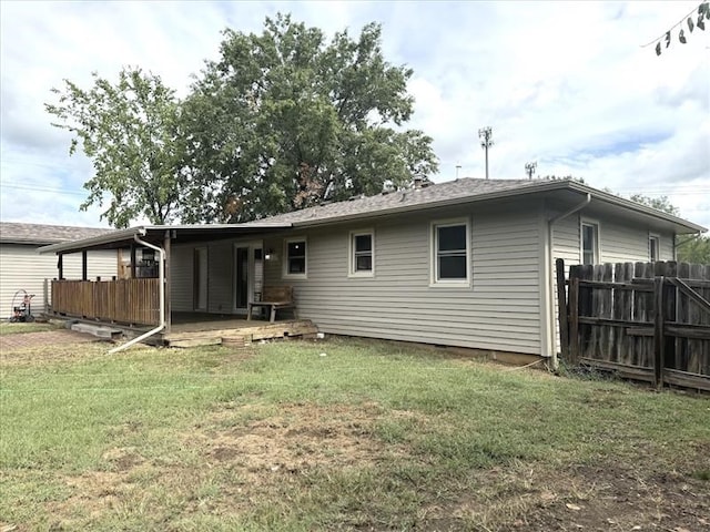 back of house featuring a yard and a deck