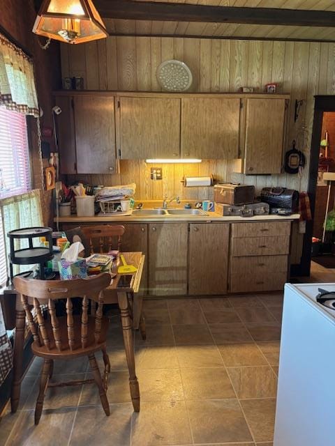 502 N Main St, Linneus, MO 64653 - kitchen featuring wooden walls, range, tile patterned floors, and a wooden ceiling with exposed beams