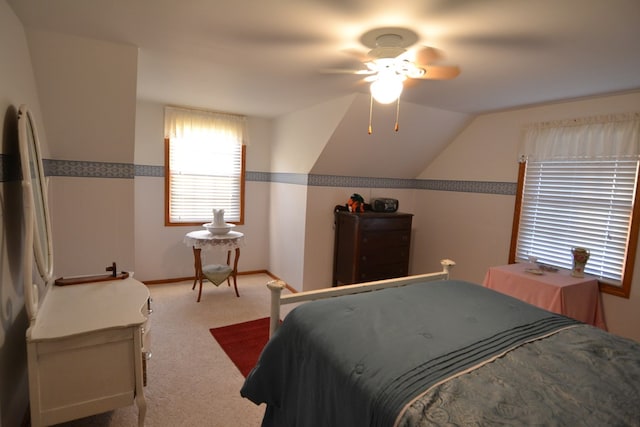 bedroom with ceiling fan, light colored carpet, and lofted ceiling