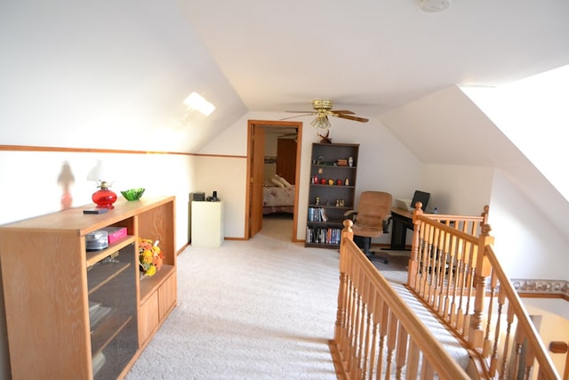 interior space featuring light colored carpet and lofted ceiling