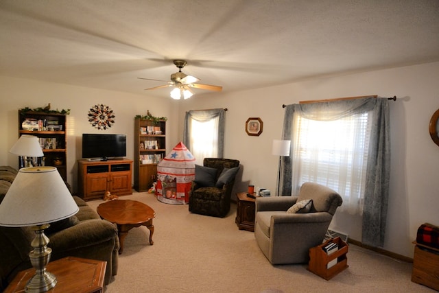 living room featuring ceiling fan and light colored carpet