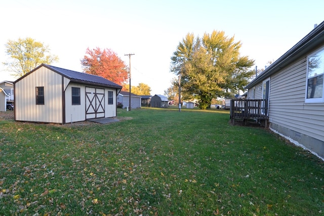 view of yard featuring a storage shed and a wooden deck