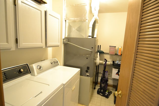 laundry area featuring cabinets and washing machine and clothes dryer