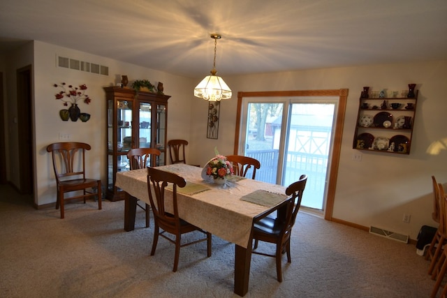 dining room featuring carpet floors and an inviting chandelier