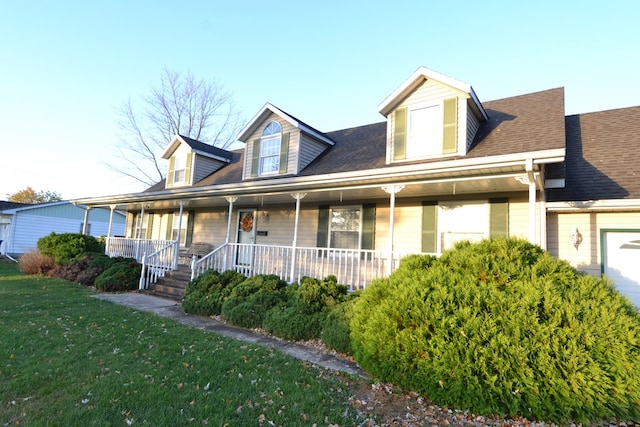 new england style home with a porch and a front lawn