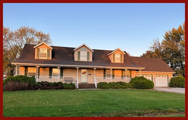 new england style home with driveway, a front yard, covered porch, and a garage