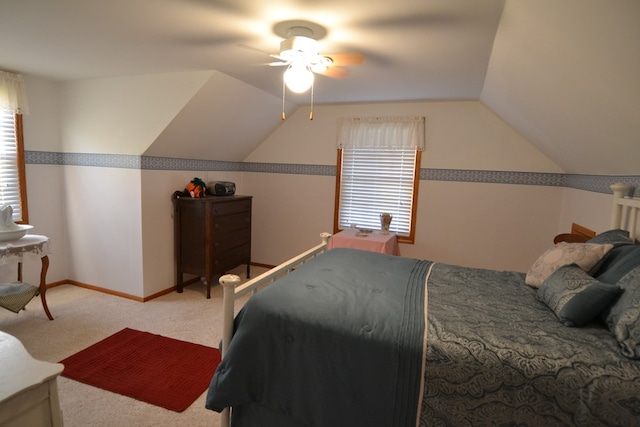 carpeted bedroom with multiple windows, ceiling fan, and lofted ceiling