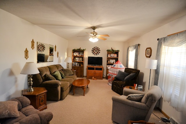 living room with ceiling fan and carpet floors