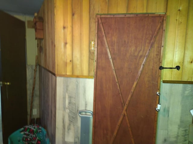 bathroom with wood walls