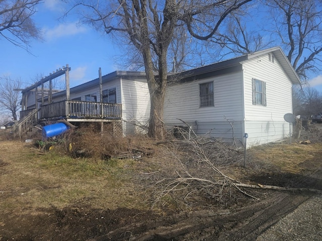 view of side of home featuring a deck