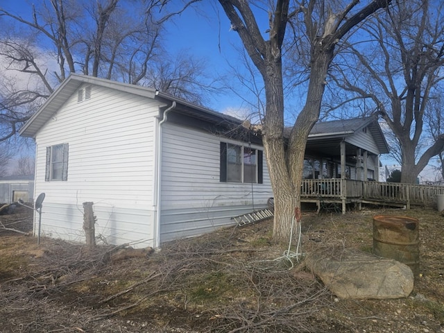 view of property exterior with a wooden deck