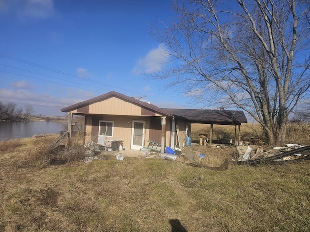 back of property with a water view