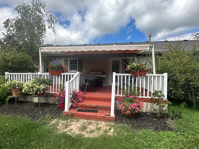 rear view of property featuring a deck