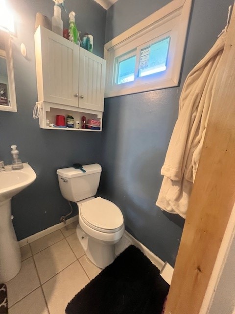 bathroom with tile patterned floors and toilet