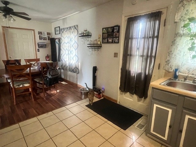 interior space featuring ceiling fan, sink, and light tile patterned flooring