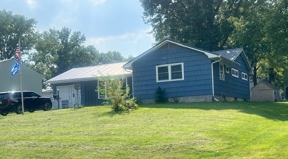 back of property with a lawn and a storage shed