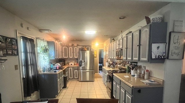 kitchen featuring light tile patterned floors and stainless steel appliances